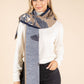 Woman wearing a patterned scarf with a neutral background