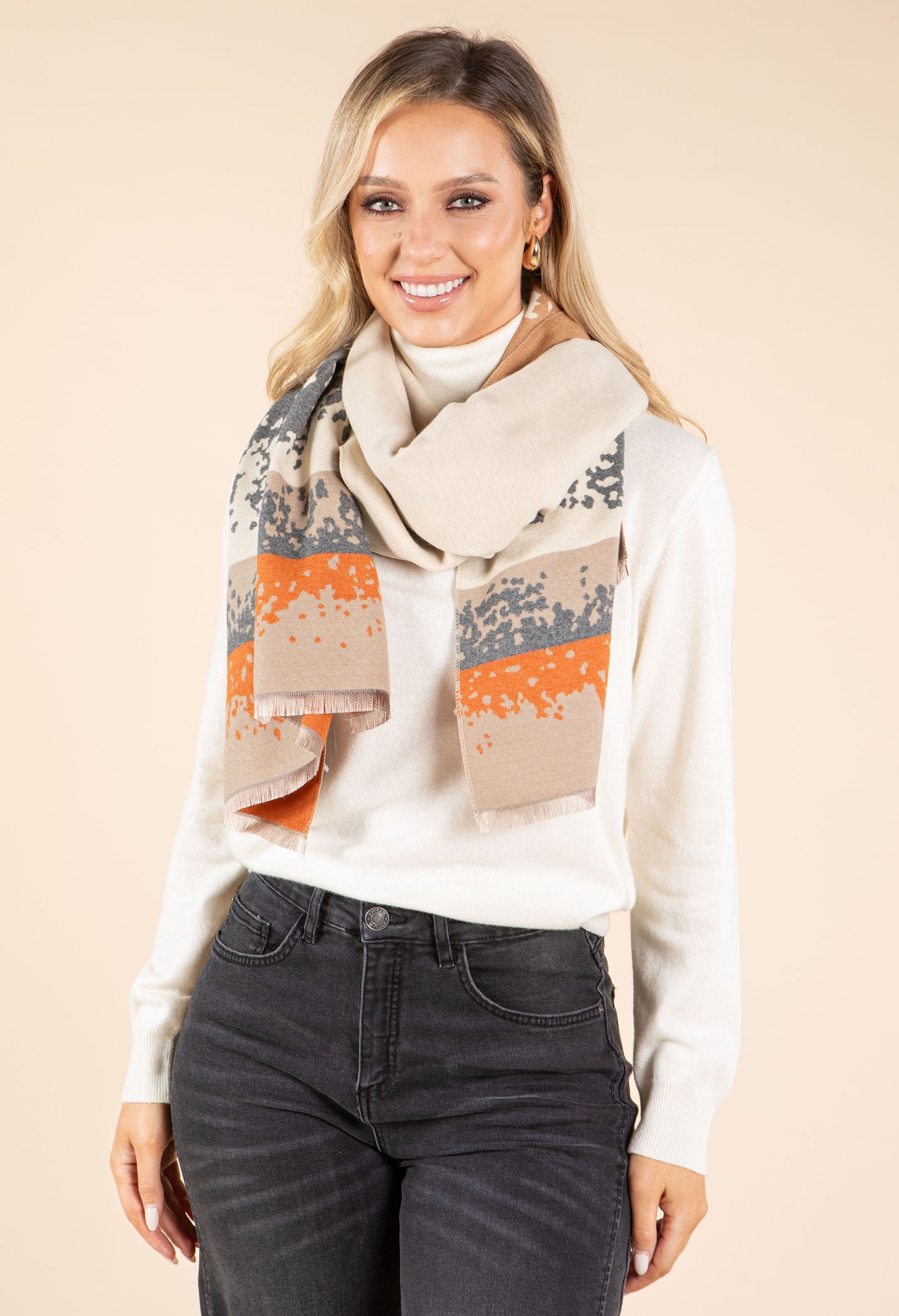 Woman wearing a patterned scarf with a neutral background