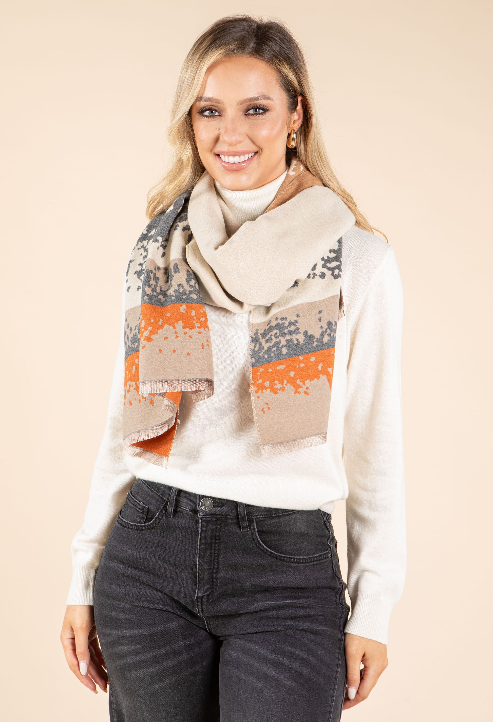 Woman wearing a patterned scarf with a neutral background