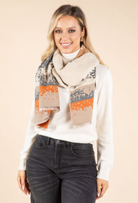 Woman wearing a patterned scarf with a neutral background