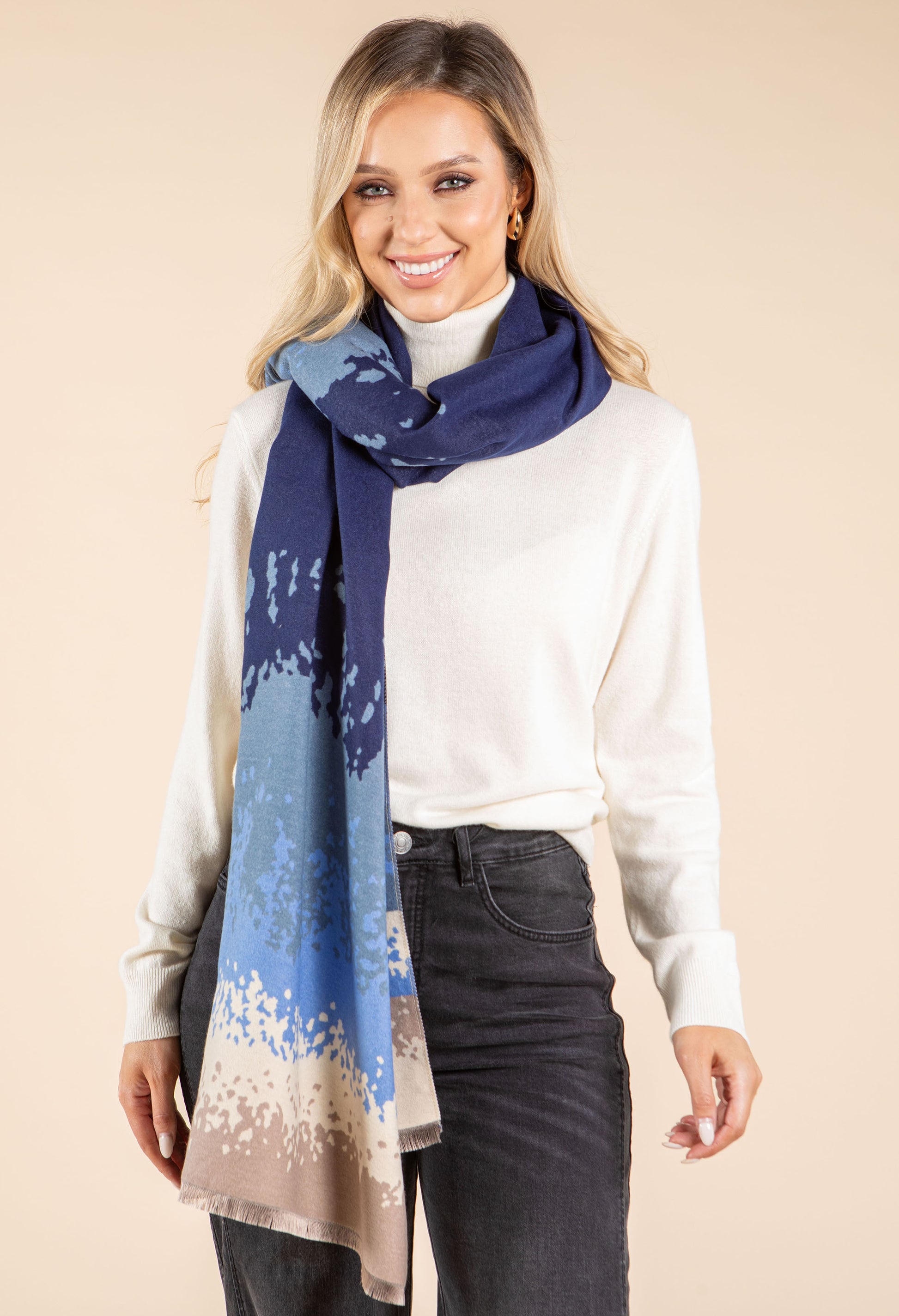 Woman wearing a blue and beige patterned scarf on a beige background