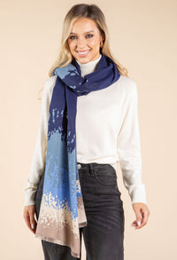 Woman wearing a blue and beige patterned scarf on a beige background