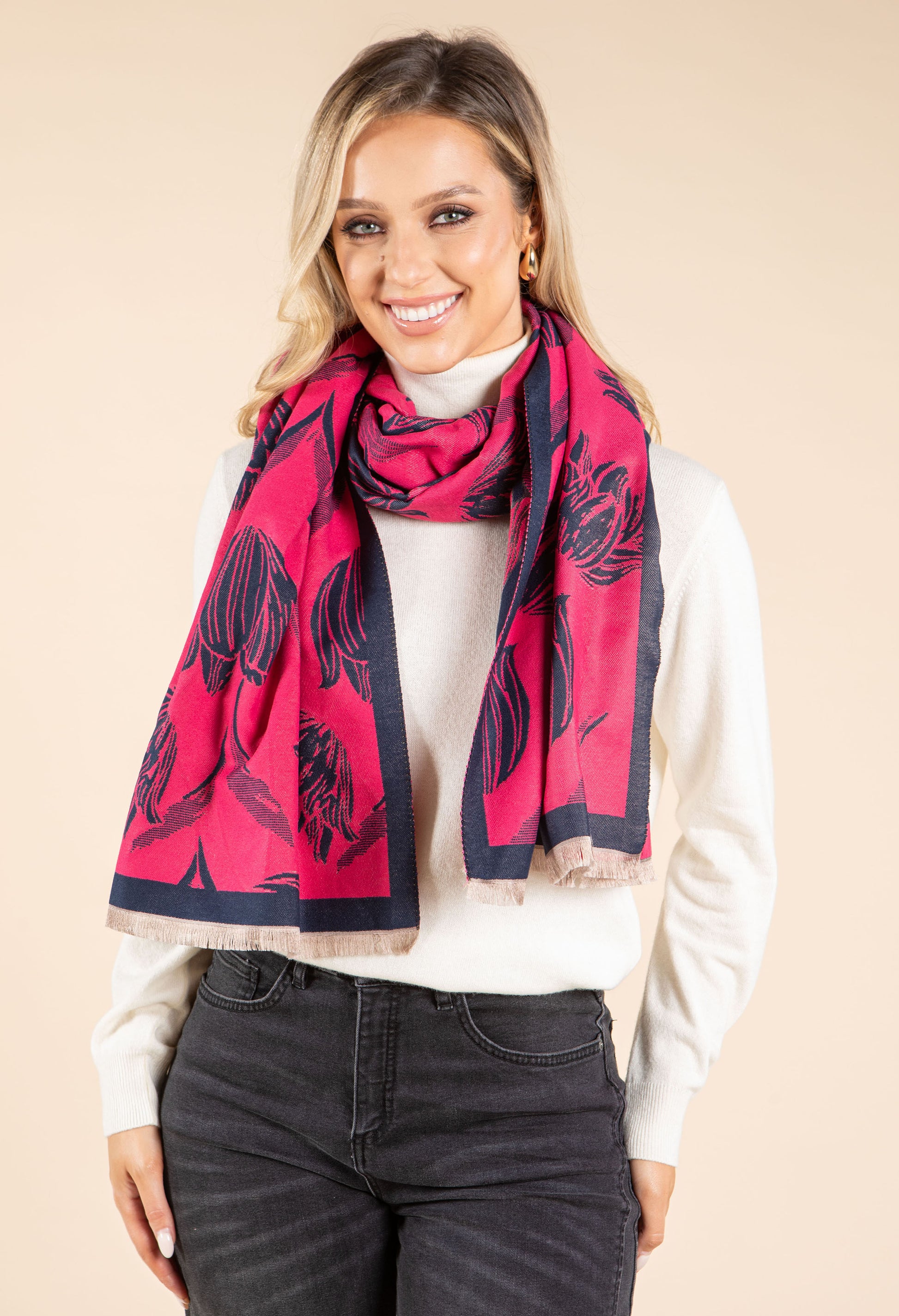 Woman wearing a pink and black patterned scarf on a beige background