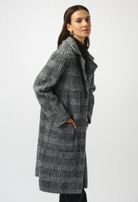 Woman wearing a gray checkered coat on a white background
