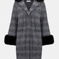 Plaid coat with black fur trim on a white background