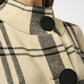 Close-up of a checkered coat with black buttons on a white background