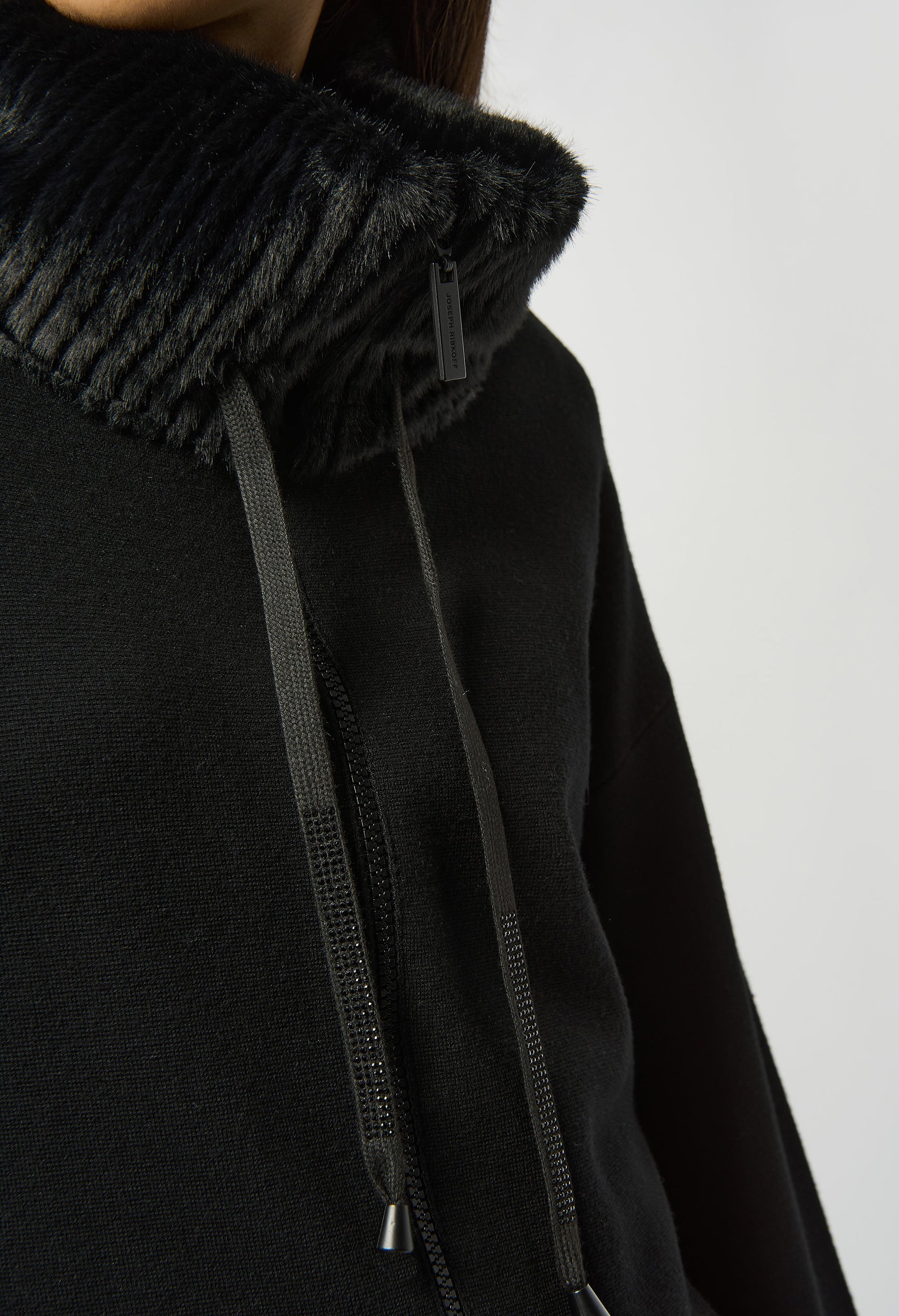 Black hoodie with textured collar on a white background