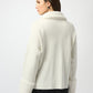 Woman wearing a cream-colored sweater on a white background