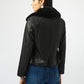 Person wearing a black leather jacket with fur collar on a white background