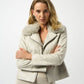 Woman wearing a light-colored jacket with fur collar on a white background