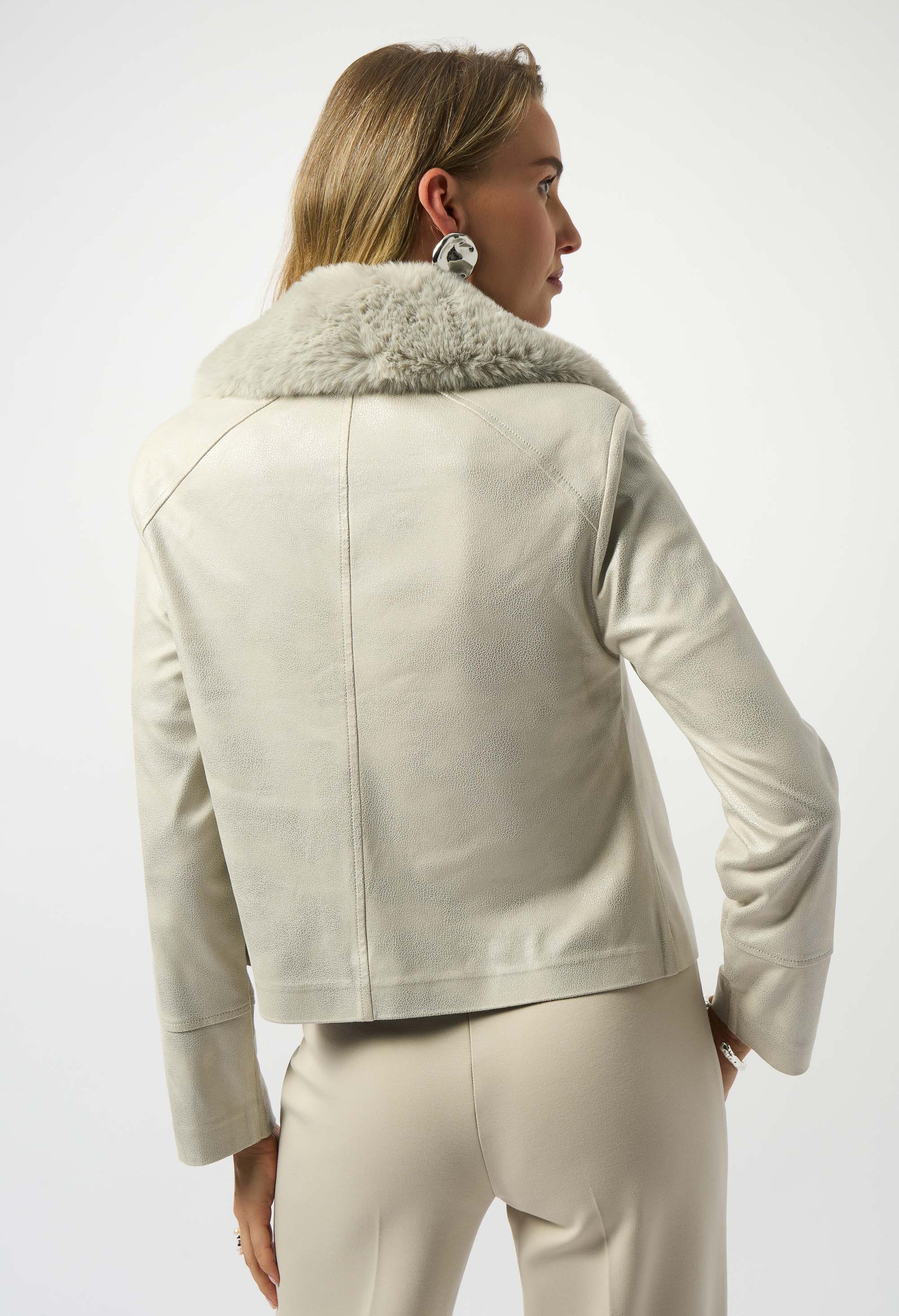 Woman wearing a beige jacket with fur collar on a white background