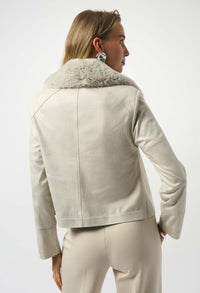 Woman wearing a beige jacket with fur collar on a white background
