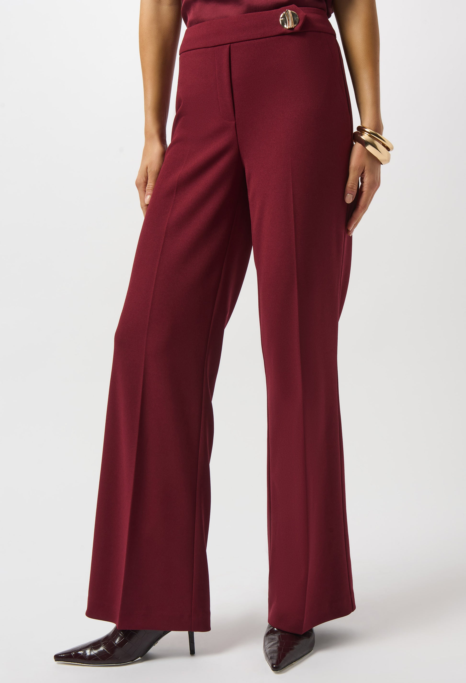 Maroon pants worn by a person on a white background
