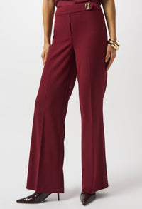 Maroon pants worn by a person on a white background