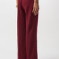 Maroon wide-leg pants worn by a person on a white background