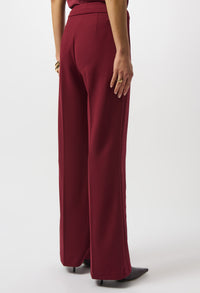 Maroon wide-leg pants worn by a person on a white background