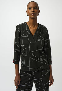 Woman wearing a black geometric patterned outfit on a white background