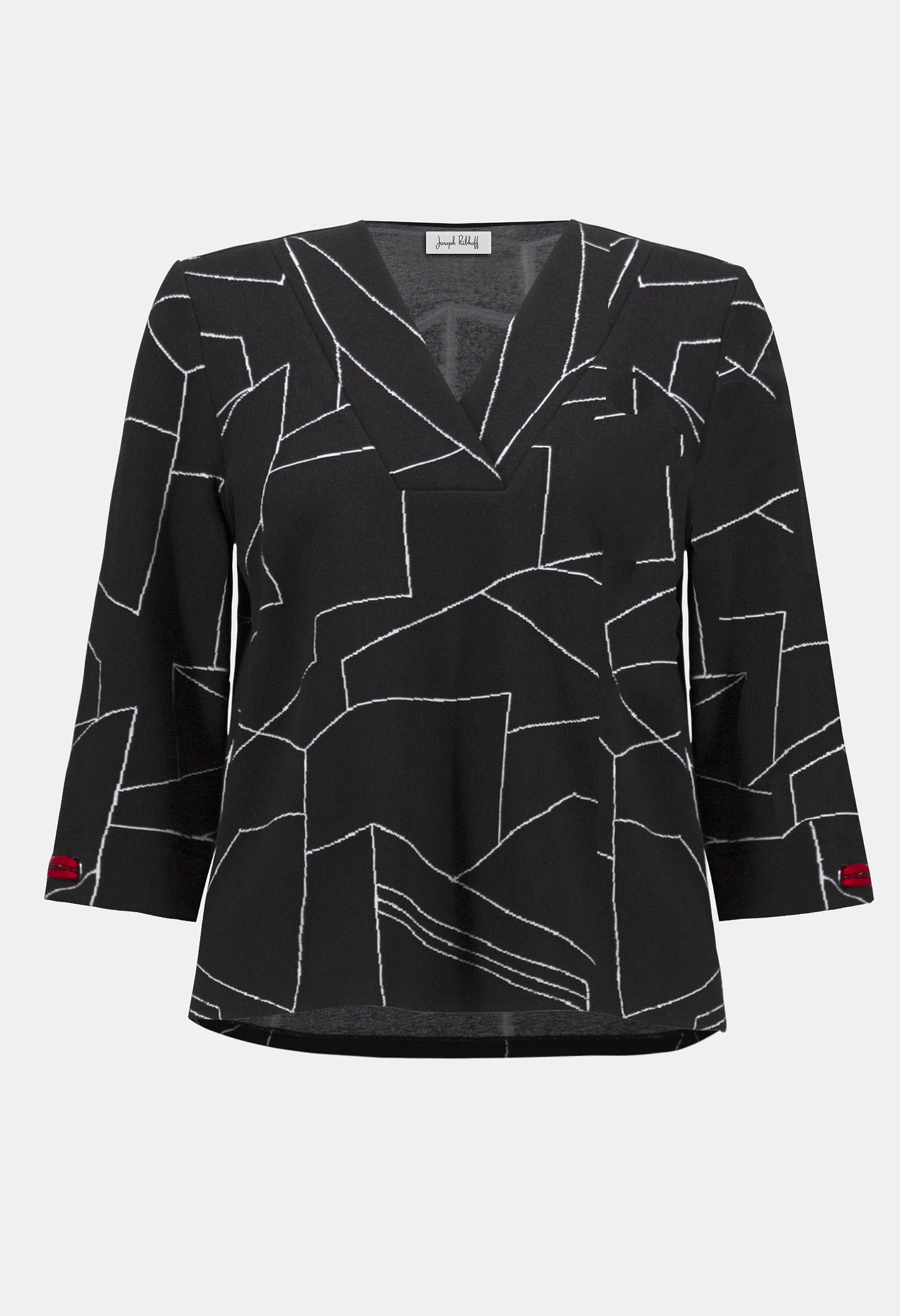 Black blouse with white geometric pattern on a white background