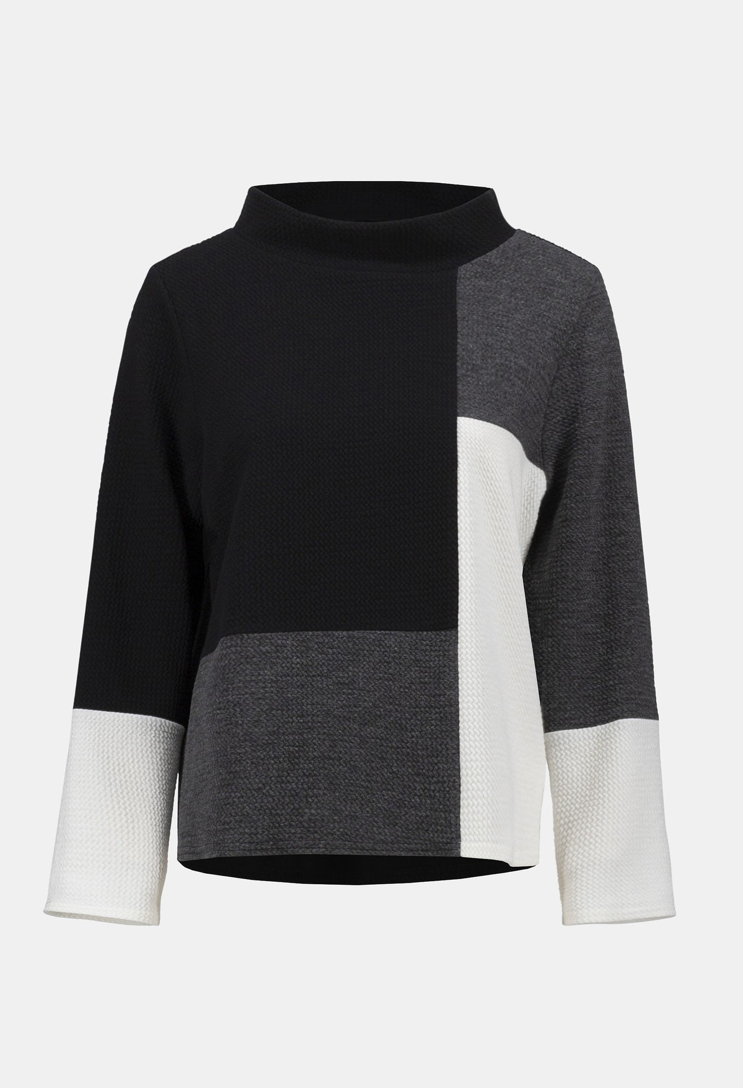 Color-blocked sweater with black, gray, and white sections on a light gray background