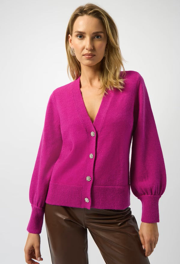 Woman wearing a bright pink cardigan on a white background