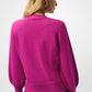 Person wearing a bright pink sweater on a white background
