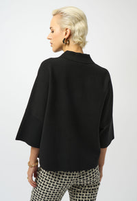 Person wearing a black jacket and patterned pants on a white background