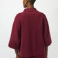 Person wearing a burgundy outfit on a white background