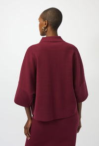 Person wearing a burgundy outfit on a white background