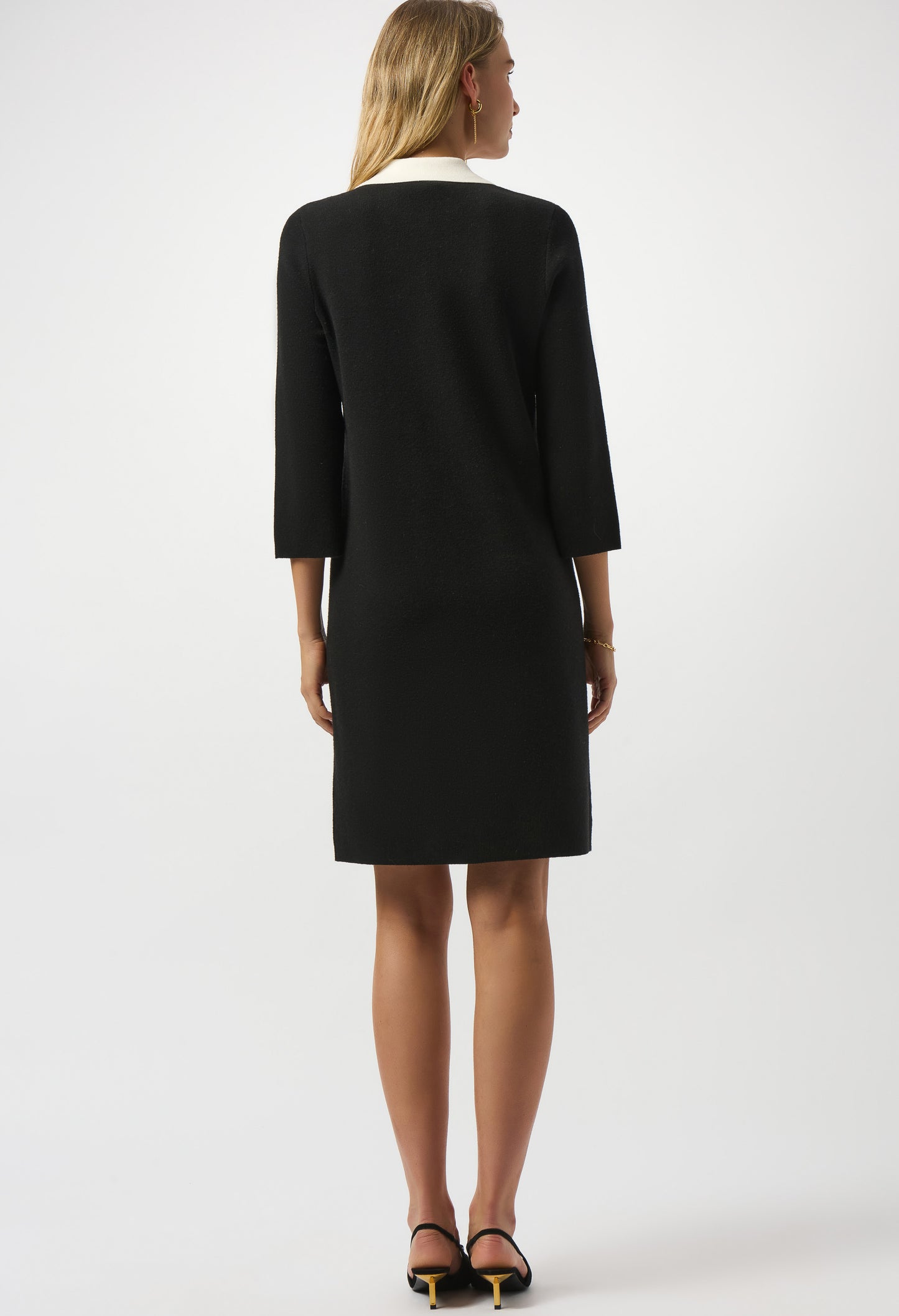 Woman wearing a black suit on a white background