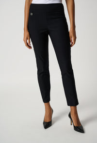 Black pants worn by a person on a white background