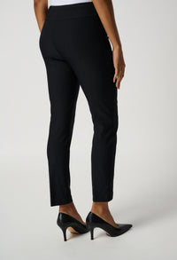 Black pants worn by a person on a white background