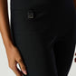 Black pants with a visible brand logo on a light background