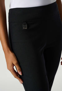 Black pants with a visible brand logo on a light background