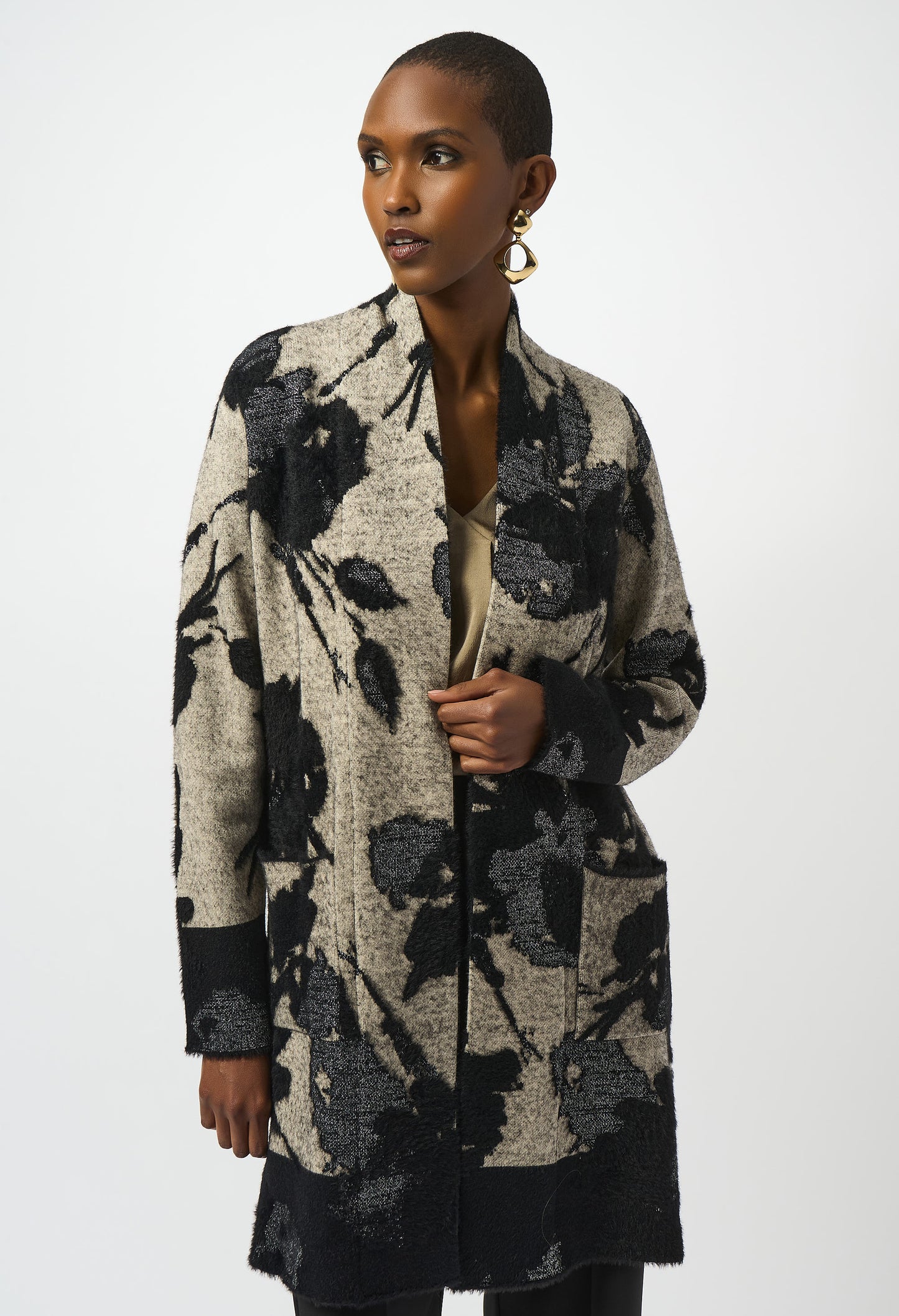 Woman wearing a floral patterned cardigan on a white background