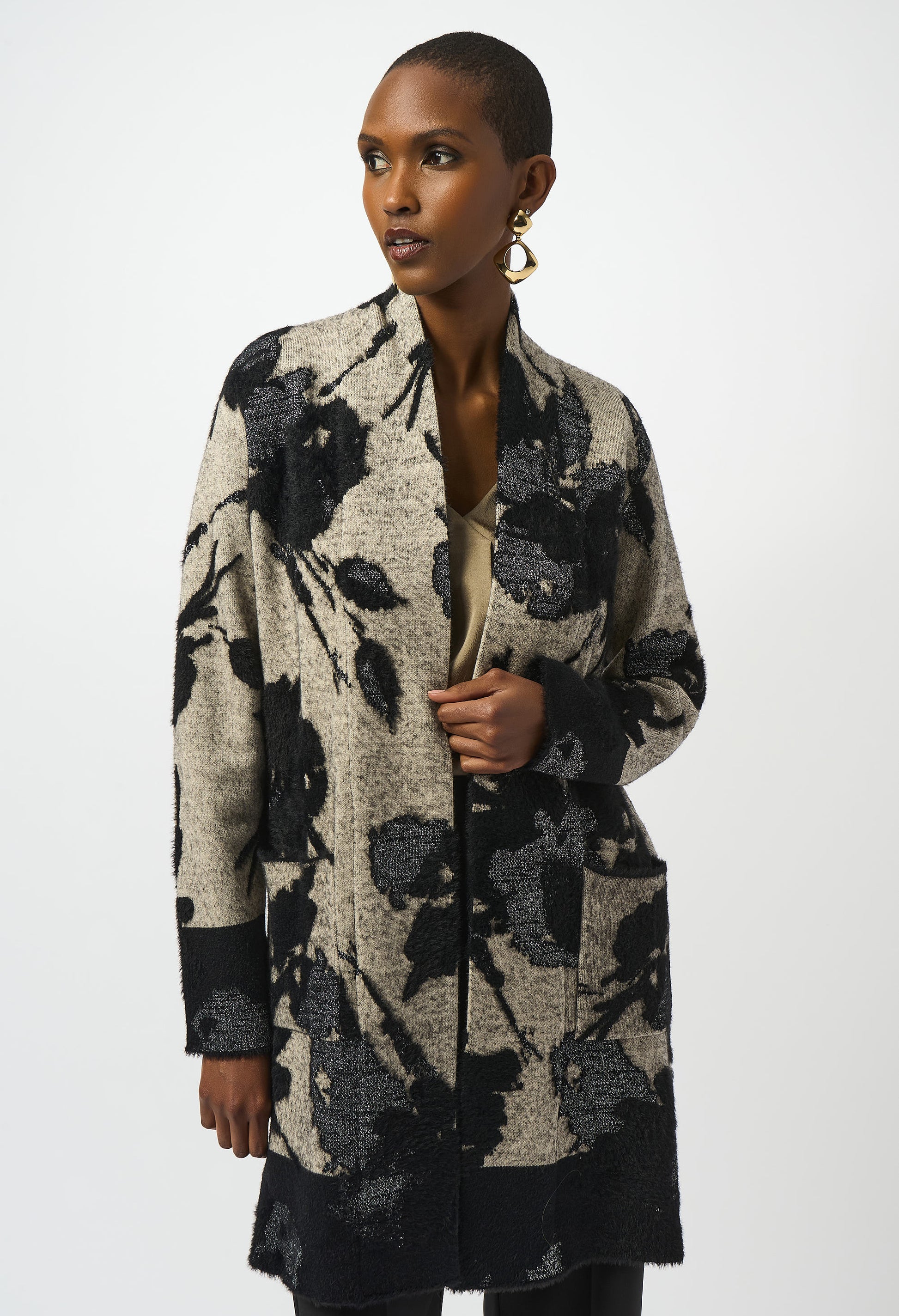 Woman wearing a floral patterned cardigan on a white background