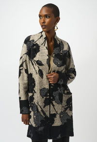 Woman wearing a floral patterned cardigan on a white background