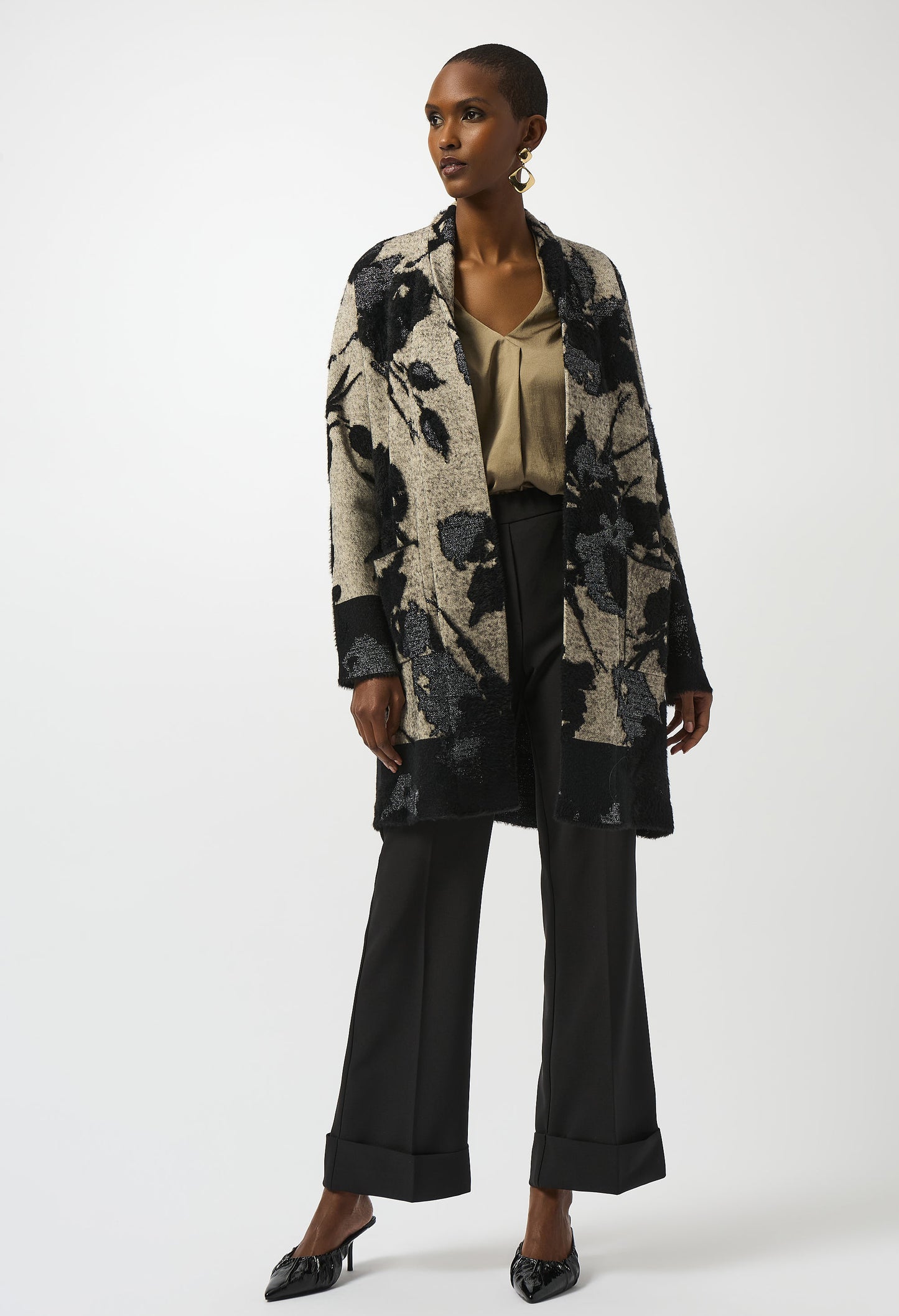 Woman wearing a floral patterned coat on a white background