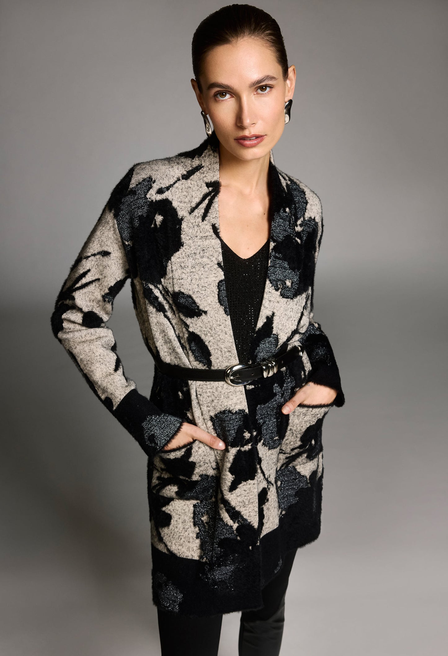 Woman wearing a floral-patterned coat against a gray background