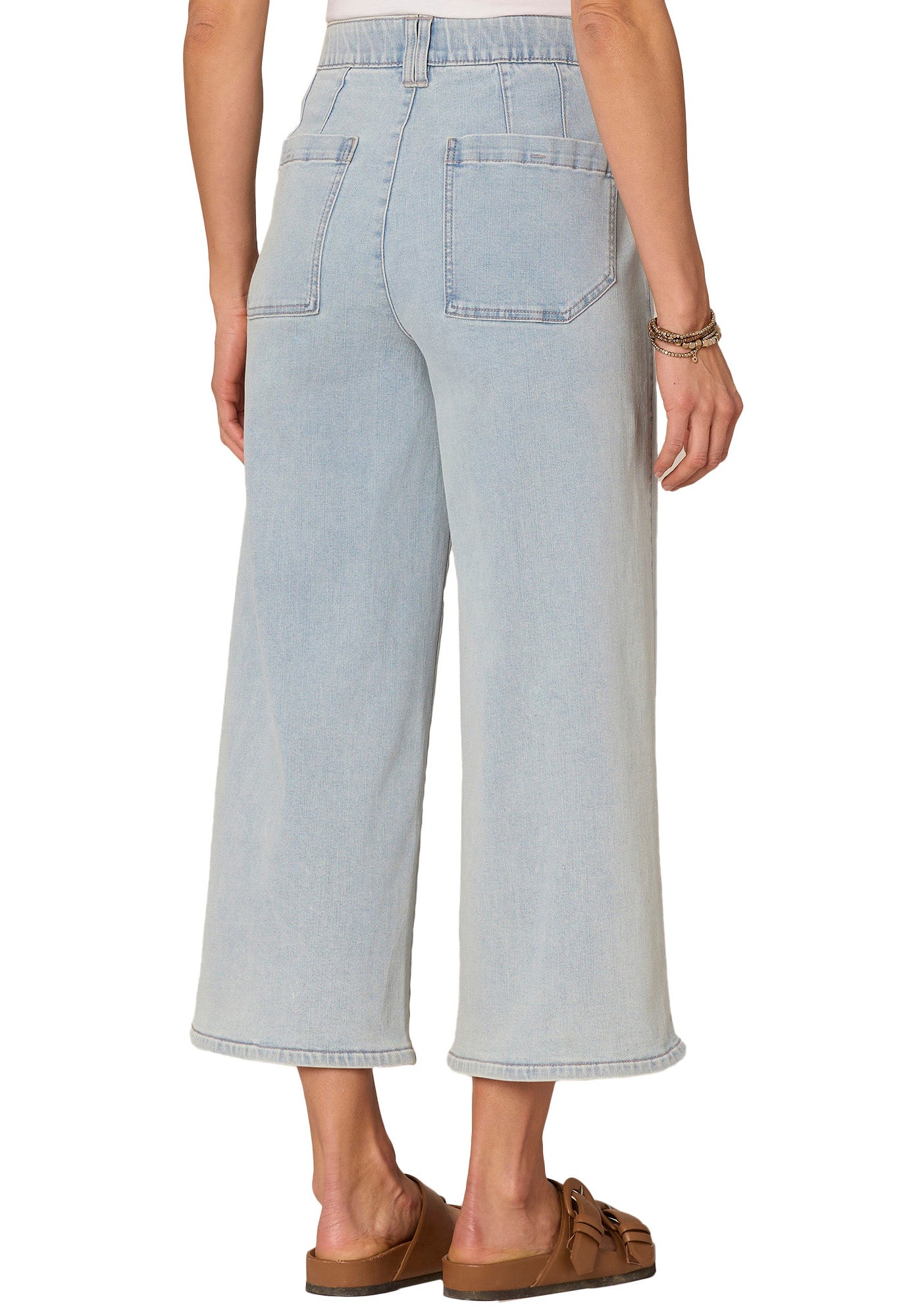 Light blue jeans worn by a person on a white background