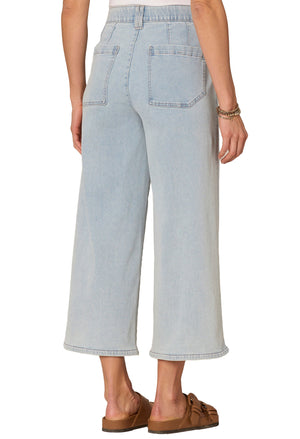 Light blue jeans worn by a person on a white background