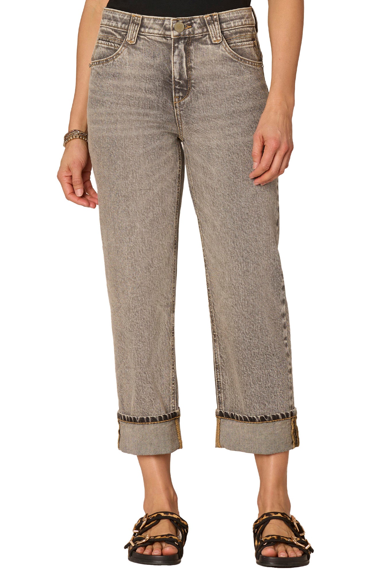 Person wearing light brown jeans with a white background