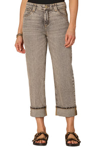 Person wearing light brown jeans with a white background