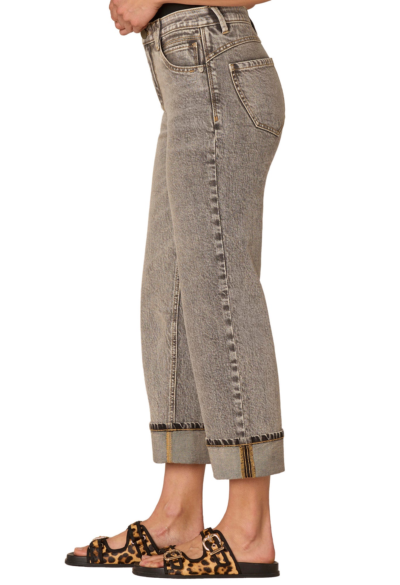 Gray jeans worn by a person on a white background