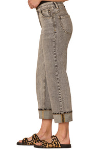 Gray jeans worn by a person on a white background