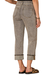 Person wearing gray jeans with a white background