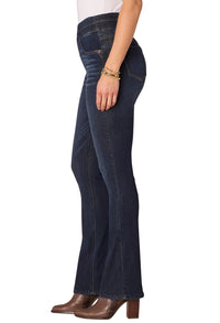 Dark blue jeans worn by a person on a white background