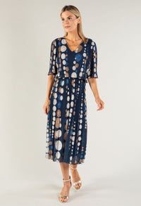 Woman wearing a blue polka dot dress on a white background