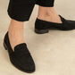 black loafer on the foot