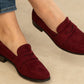 wine coloured loafer on the foot