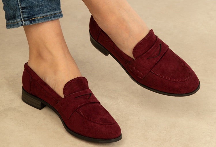 wine coloured loafer on the foot